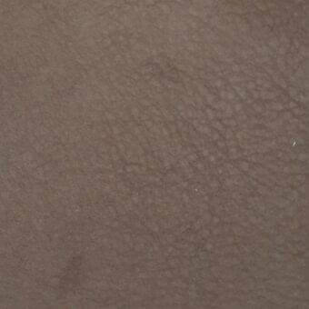 Nabuk leather Rugiano rug in matte brown, displaying a uniform color and finely pebbled texture with a dense, velvety surface.